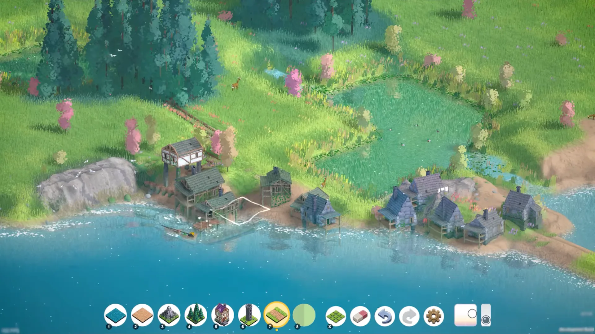 Lakeside half-timbered houses with a white selection box on one building and the Brushland build toolbar along the bottom of the screen.